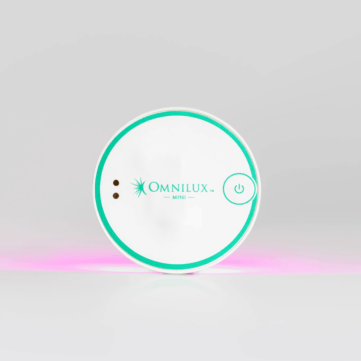 Omnilux Mini device packaging on a gray background